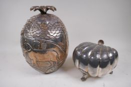 A silver foiled composition ice bucket embossed with primitive images of animals, with palm tree