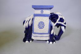 A Chinese ceramic garden seat in the form of an elephant with blue and white decoration, 39cm high