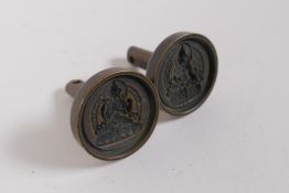 A pair of Tibetan cast bronze Tsa Tsa molds of Buddha, 3.5cm diameter