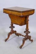 A Victorian inlaid walnut work table with lift up top revealing a fitted interior, raised on