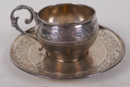 An antique French silver christening cup and saucer with delicate engraved decoration marked A Vague