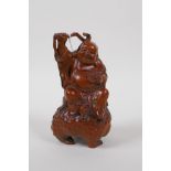 A Chinese boxwood carving of Buddha seated on the back of Chan Chu (three legged toad), 14cm high