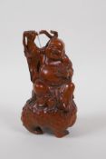 A Chinese boxwood carving of Buddha seated on the back of Chan Chu (three legged toad), 14cm high