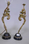 A pair of antique ormolu table lamps in the form of putti seated upon the backs of doves, 45cm high