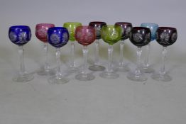 Eleven cut and coloured drinking glasses, 20cm high