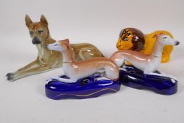 A pair of Staffordshire pottery greyhound inkwells, 16cm long, a continental  porcelain figure of