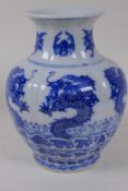 A C19th Chinese blue and white baluster vase decorated with dragons, 4 character mark to base,