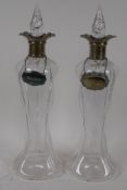 A pair of Art Nouveau glass decanters with hallmarked silver collars, Birmingham 1904, 35cm high,