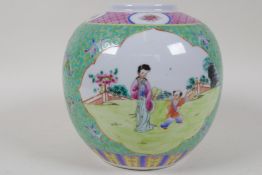 A Chinese storage jar decorated with panels of figures in garden scenes painted in bright enamels on