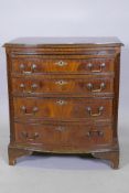 A Regency style mahogany bowfront chest, the brushing slide over four graduated drawers with handcut