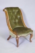 A Victorian walnut button back nursing chair on carved cabriole supports, 82cm high
