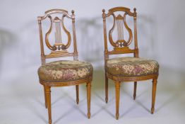 A pair of C19th French carved beech wood lyre back side chairs with original tapestry seat covers,