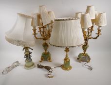 A pair of spelter and onyx five light table lamps, 57cm high, and two other gilt spelter and onyx