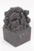 A bronze seal cast with a dragon and young, with Chinese character marks to seal, 8.5cm square, 14cm