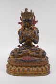 A Sino Tibetan gilt bronze figure of Buddha seated on a lotus throne, 33cm high