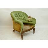 A Victorian walnut tub shaped easy chair with caned seat, raised on turned supports