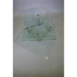 A glass coffee table with two revolving tiers, 90 x 90 x 42cms
