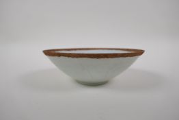 A Chinese song style celadon glazed porcelain dish with incised figural and floral decoration, 7cm