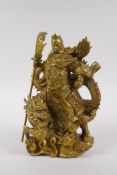 A Chinese gilt metal figure of Guan Yu, with a dragon 22cm high