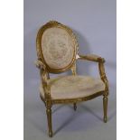 A Louis XV style gilt painted spoon back open arm chair, raised on fluted supports