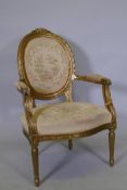 A Louis XV style gilt painted spoon back open arm chair, raised on fluted supports