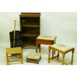 An oak open bookcase, a satin mahogany sewing stool and similar stool, a mahogany foot stool with