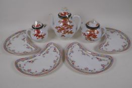 A Japanese eggshell porcelain three piece teaset decorated with acer leaves, teapot 19cm high, and a