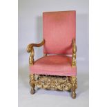 A C19th carved and gilt oak high back throne chair, with scrolled end arms, raised on carved