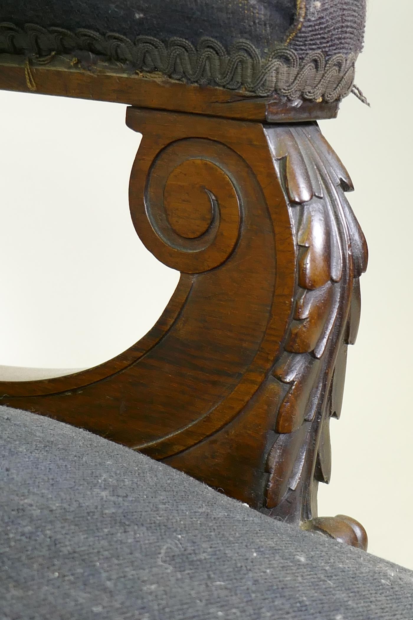 A Victorian show frame rosewood arm chair, with carved arms, raised on turned supports with brass - Image 3 of 5