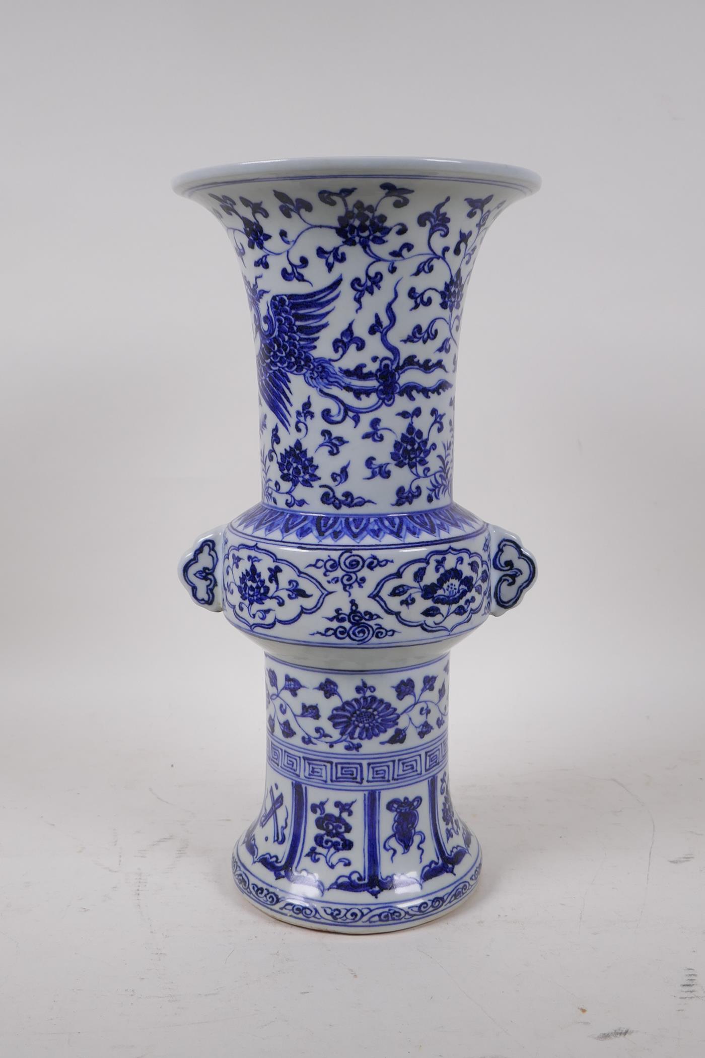 A Chinese Ming style blue and white porcelain gu shaped vase with two handles decorated with a
