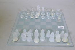 A glass chess set and board, 35 x 35cm, king 7.5cm high