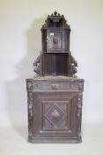 C19th oak corner cupboard, with single drawer and two cupboards, carved with griffins and lion