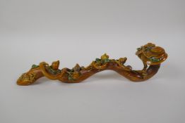 A Chinese Sancai glazed porcelain ruyi with peach tree decoration, 32cm long