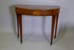 A Georgian D shaped mahogany card table, the fold over top inlaid with satinwood and fiddle back