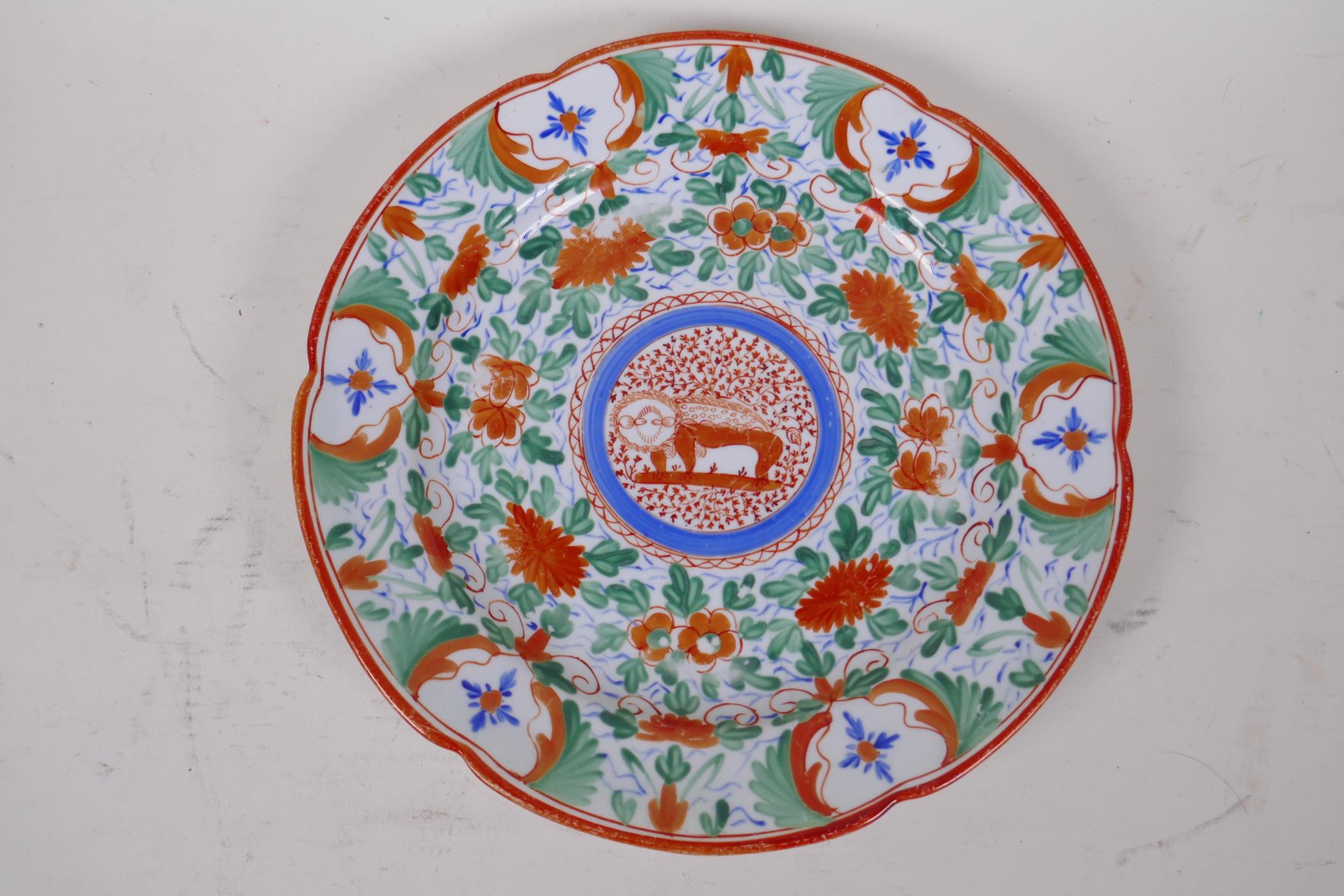 A rare export ware plate painted with flowers and a stylised lion, 24cm diameter, AF