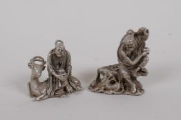 A Chinese miniature white metal figure of Lohan, and another similar, 4cm high