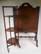 A vintage oak three tier folding cake stand, 86cm high, and an oak and leather fire screen