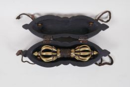 A Tibetan  ceremonial bronze vajra in a carved wood carry case, 25cm long