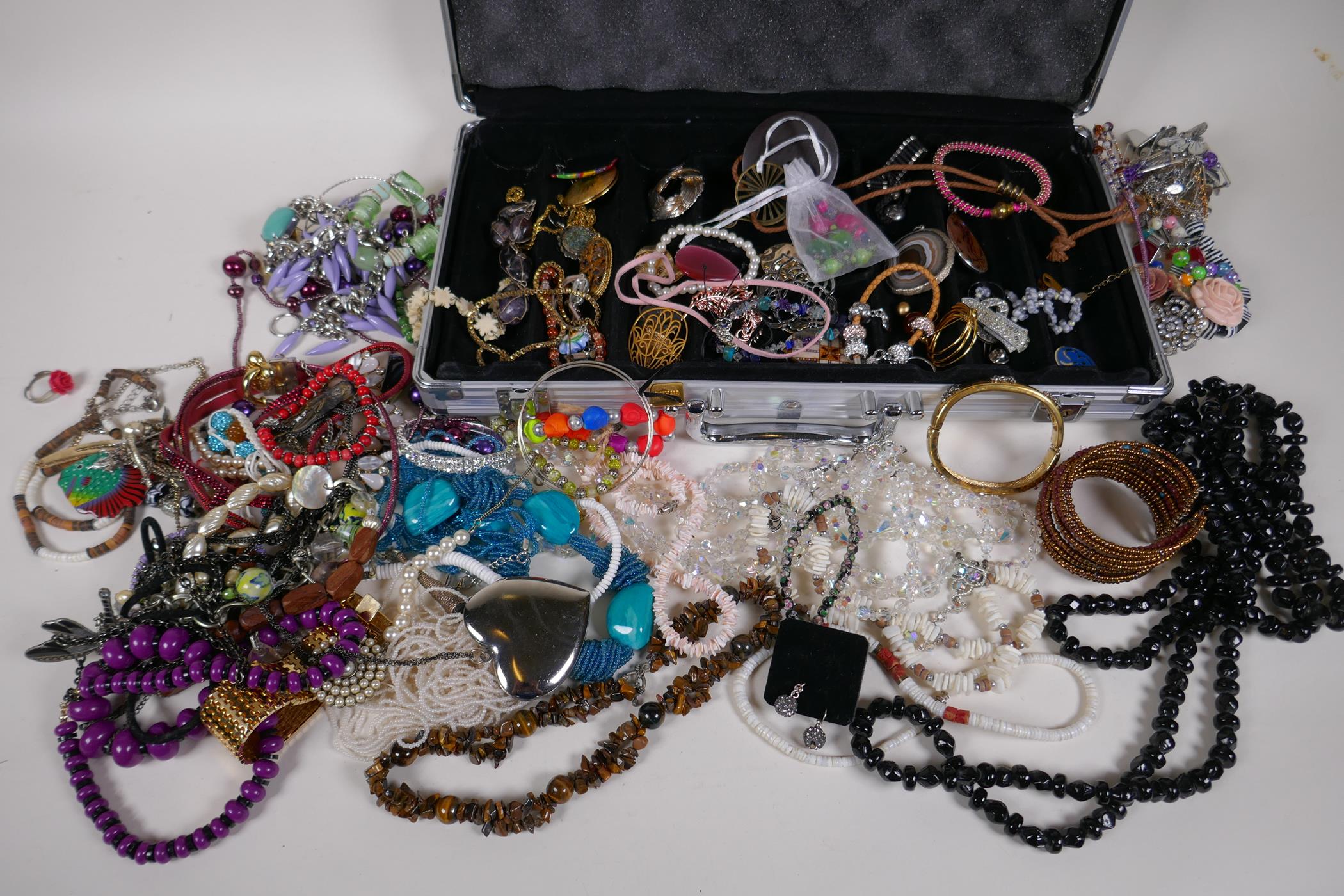 A quantity of costume jewellery in an aluminium flight case