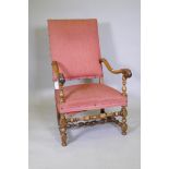 A C19th walnut high back throne chair with carved and scrolled arms, raised on turned supports