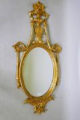 A giltwood wall mirror with swag and scroll decoration, 60 x 125cms