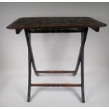 A C19th oak folding occasional table with carved and poker work tops, 62 x 61 x 37cms