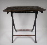 A C19th oak folding occasional table with carved and poker work tops, 62 x 61 x 37cms