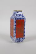 A small blue and white porcelain vase with iron red panels decorated with birds and flowers in gilt,