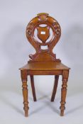 A Victorian mahogany hall chair with carved and pierced back