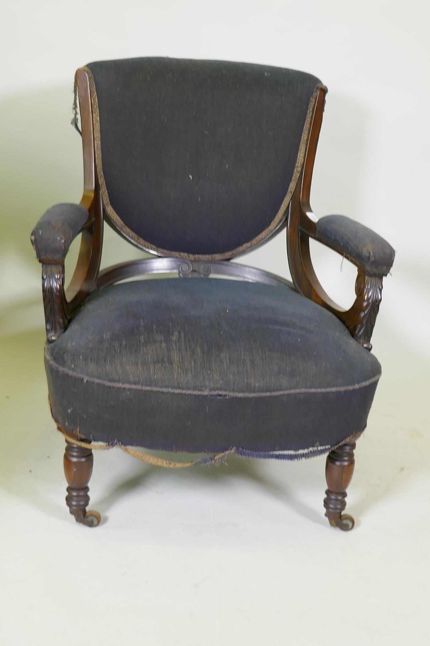 A Victorian show frame rosewood arm chair, with carved arms, raised on turned supports with brass - Image 2 of 5