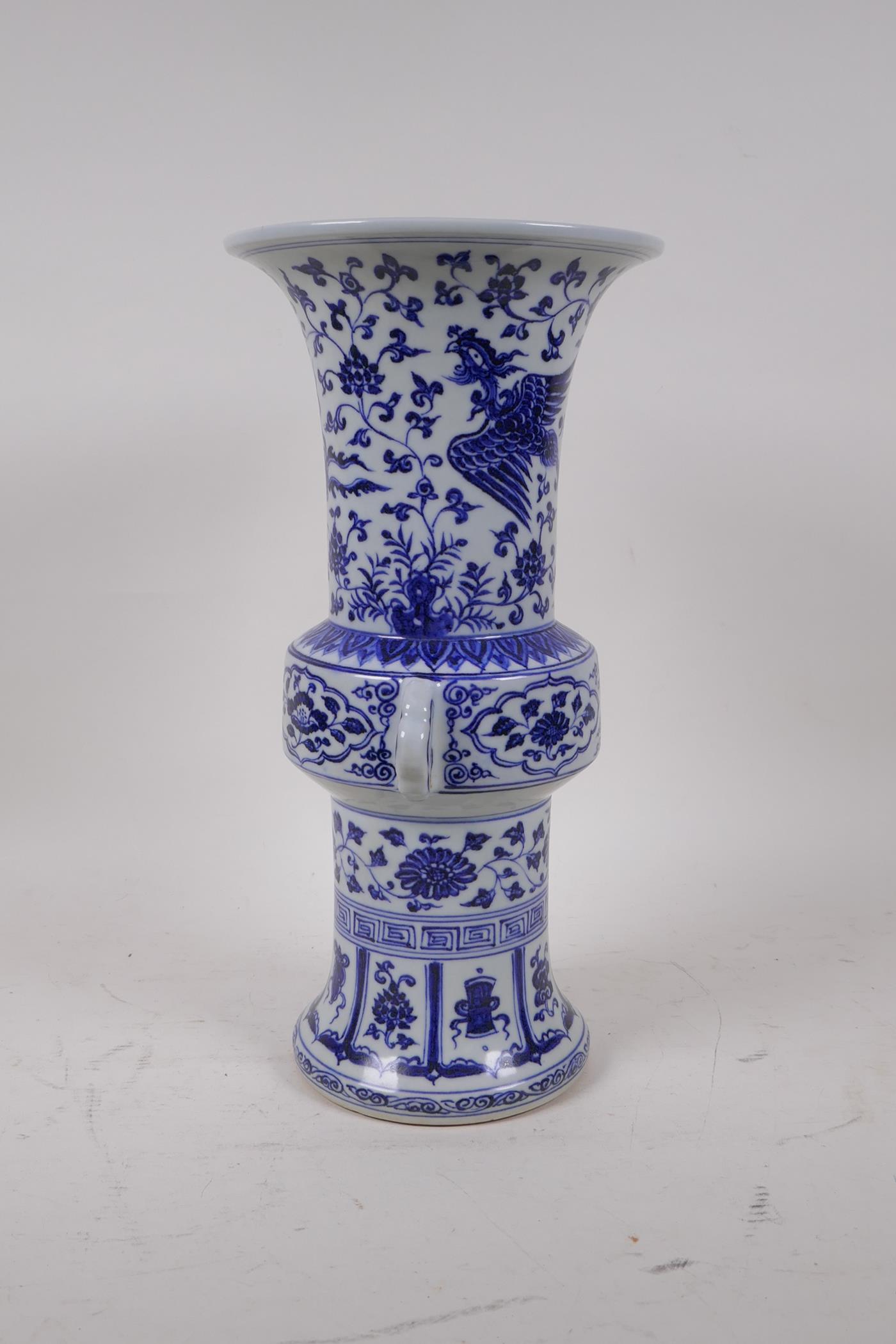 A Chinese Ming style blue and white porcelain gu shaped vase with two handles decorated with a - Image 4 of 6