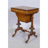 A Victorian inlaid walnut work table with lift up top revealing a fitted interior, raised on