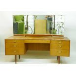 A 1970s Meredew teak dressing table and stool, with triptych mirror and seven drawers, 163 x