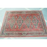 A red ground Persian pattern Belgian rug, 200 x 140cms